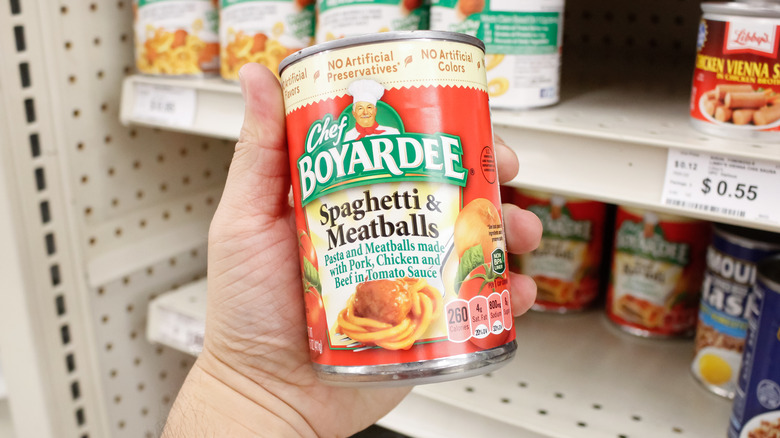 Hand holding can of Chef Boyardee