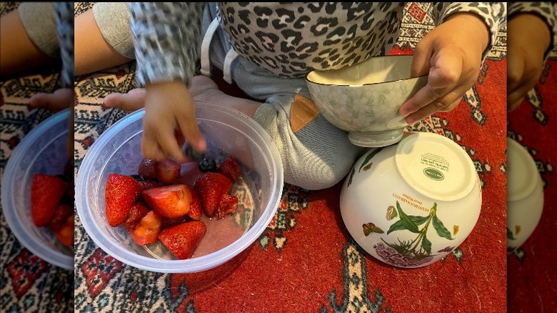 kid playing with bowls