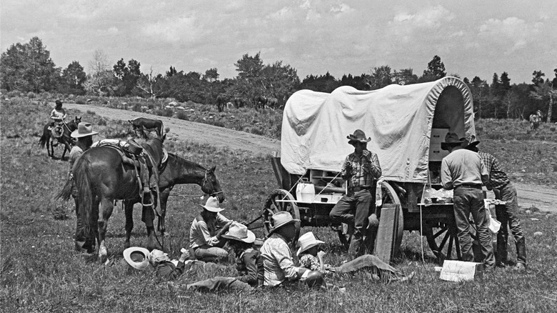 cowboys gather around chuck wagon