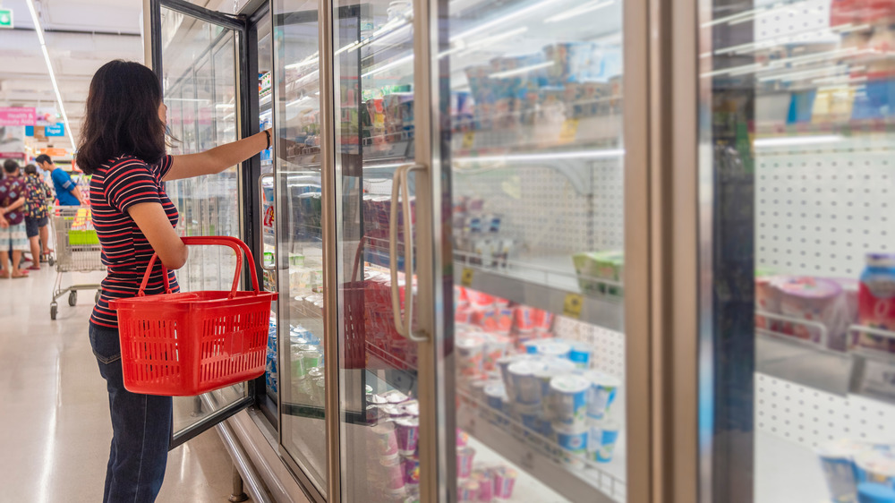 Person shopping in the frozen food aisle