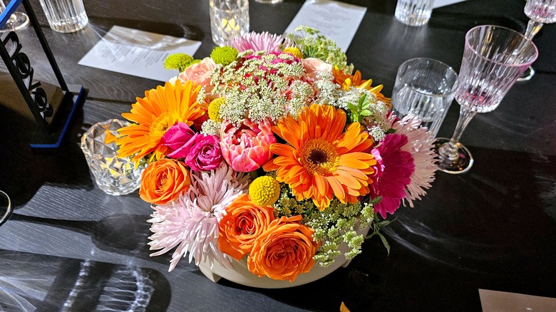 A centerpiece of Gerber daisies and roses