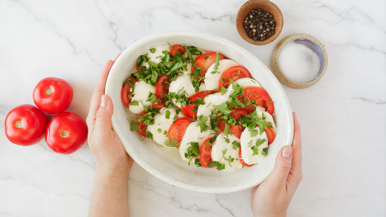 hands holding baking dish