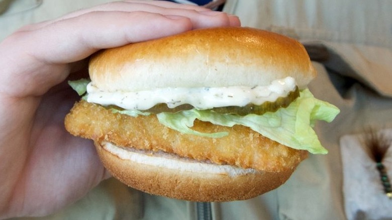 Hand holding Wendy's fish sandwich