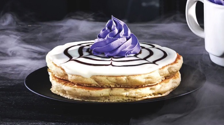 Two pancakes with purple whipped cream