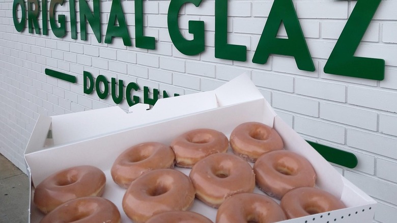 original glaze sign and doughnuts 