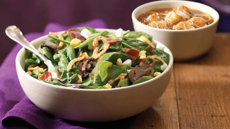 Bowl of spinach salad and soup