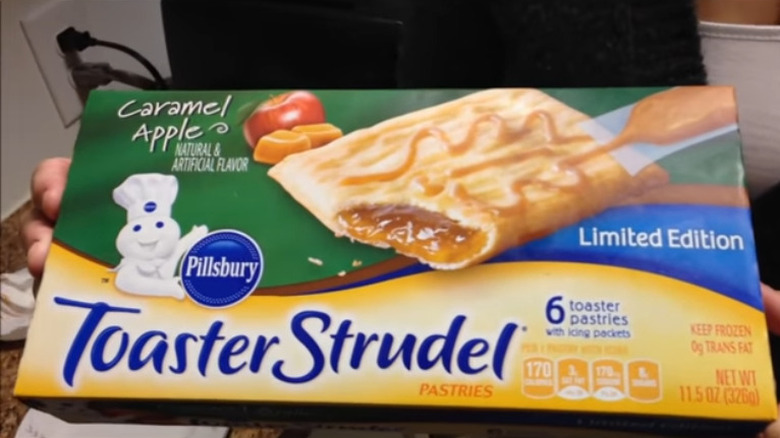 Person holding Caramel Apple Toaster Strudel box