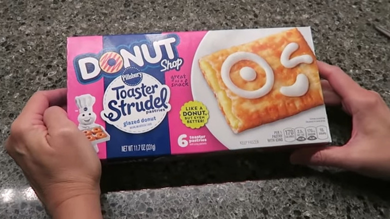 hands holding Donut shop Toaster Strudels box