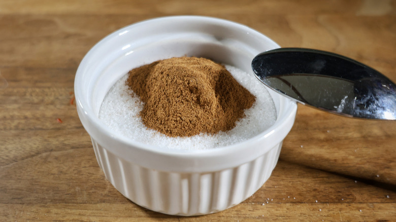 ramekin of sugar with cinnamon on top and spoon resting on the side