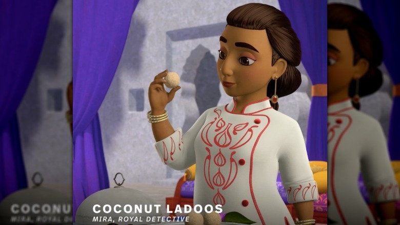 woman holding coconut ladoo in "Mira, Royal Detective"