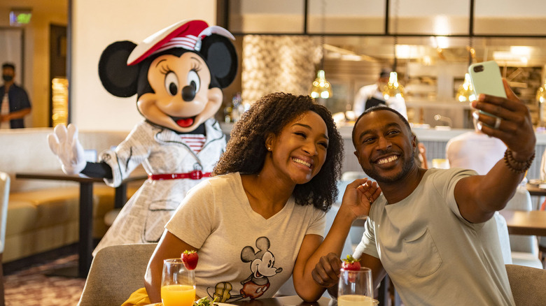 Minnie Mouse poses with couple