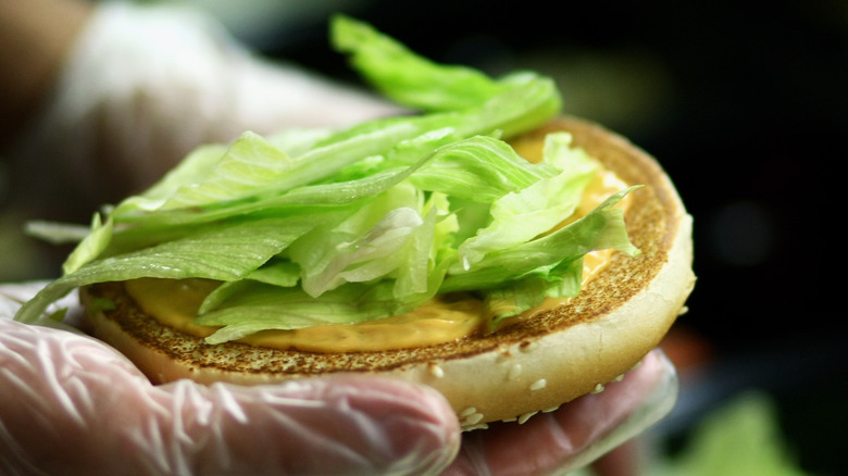 Whopper bun with lettuce in hand