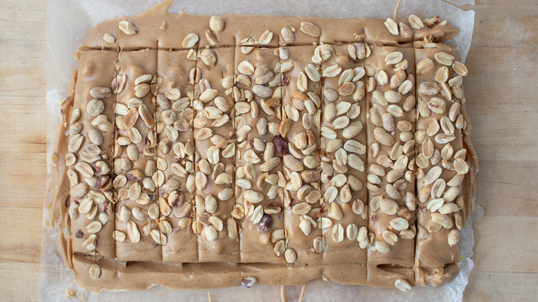 trimming peanut bars on sheet