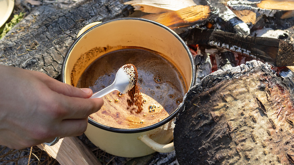 Pot of coffee over a campfire