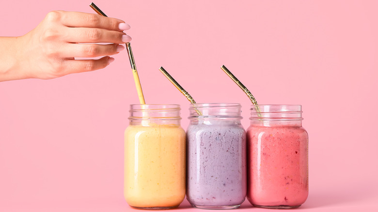 brightly colored smoothies in mason jars