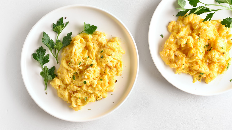 Two plates of scrambled eggs