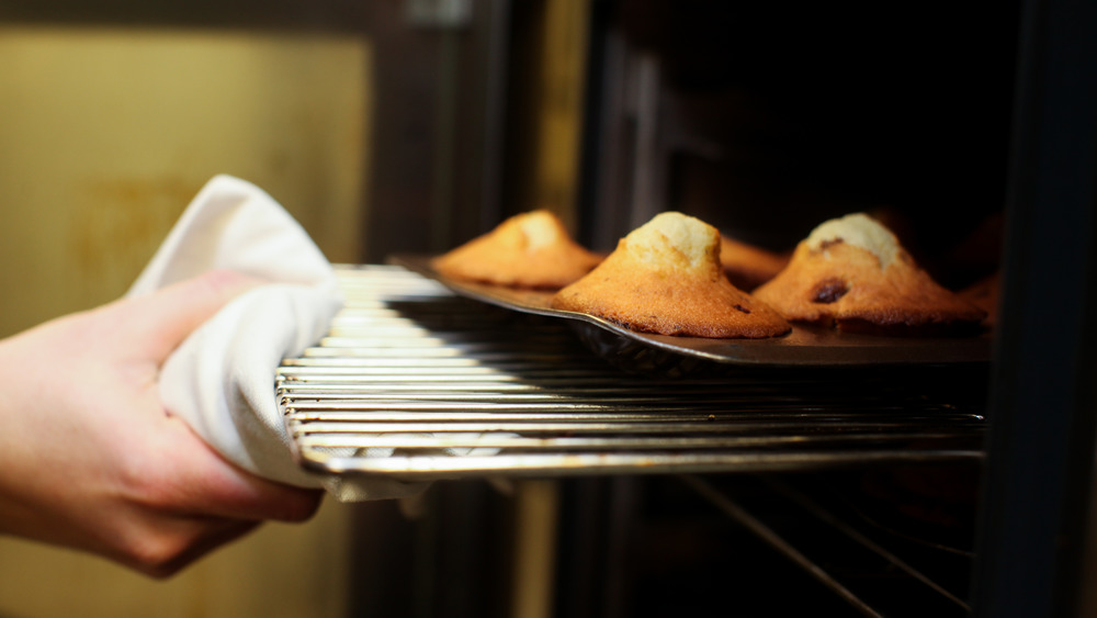 Taking madeleines out of the oven