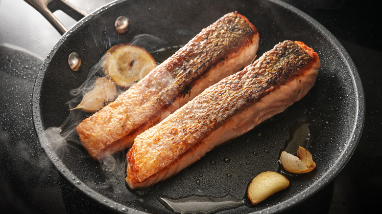 two pieces of salmon in pan