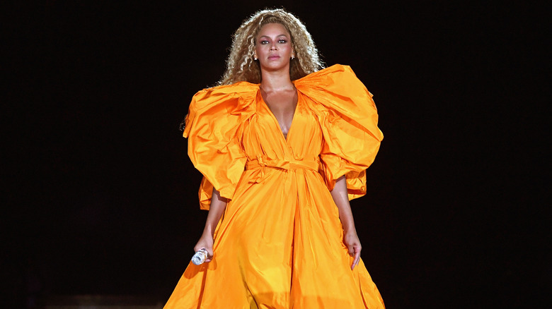 Beyoncé in orange dress on stage