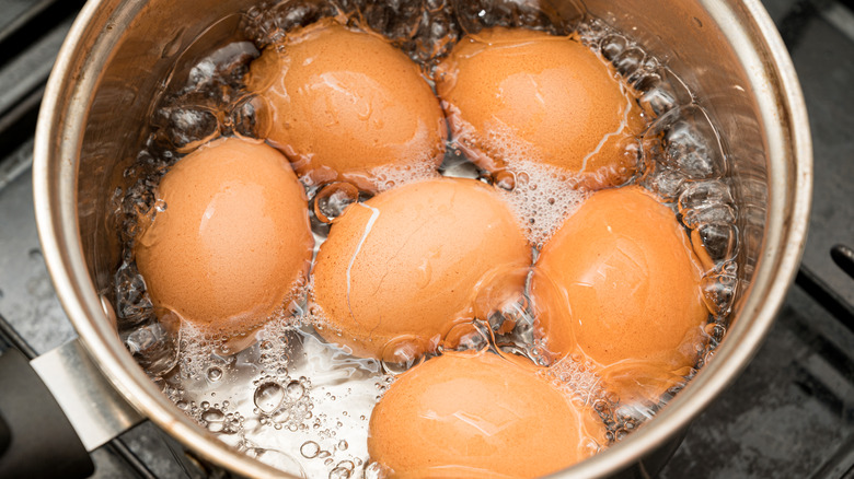 Eggs boiling in pot