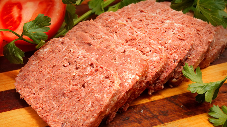 Canned corned beef on cutting board