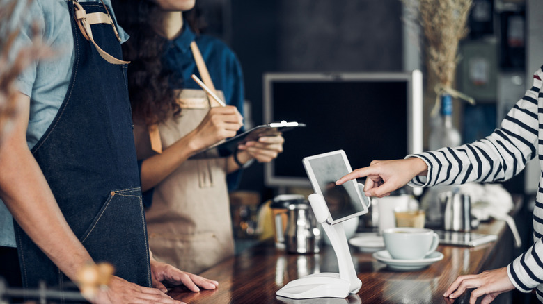 Waiter taking an order from customer