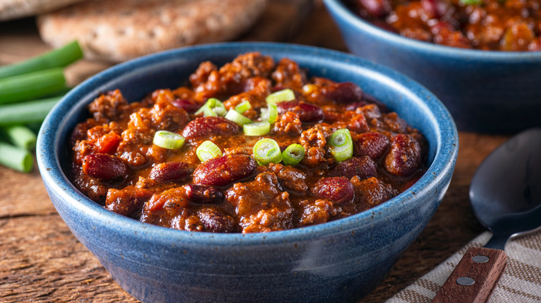 Chili in a blue bowl with a spoon