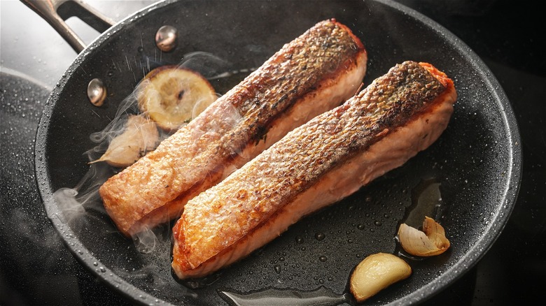 Salmon frying in a pan