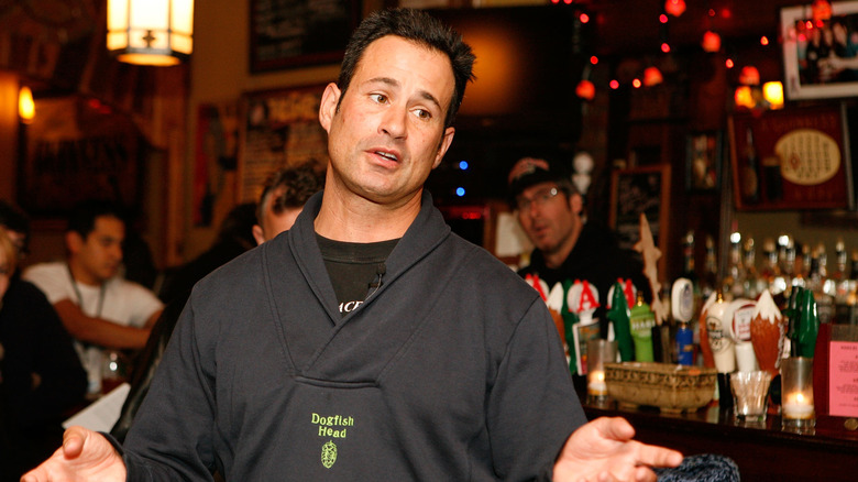 Sam Calagione speaking in a bar by the beer taps