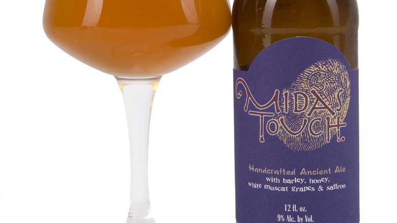 A glass and bottle of Midas Touch Ale