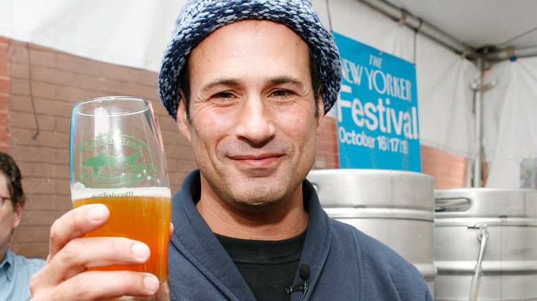 Sam Calagione holding up a beer