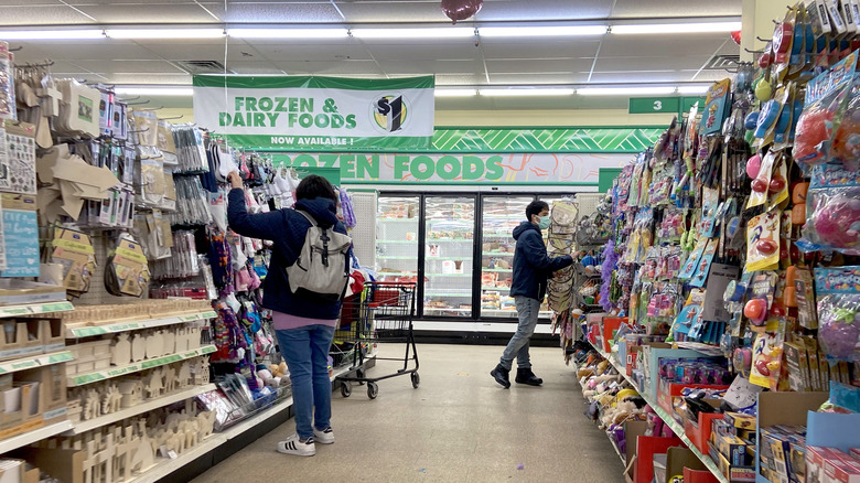 Dollar Tree store with shoppers looking through aisles