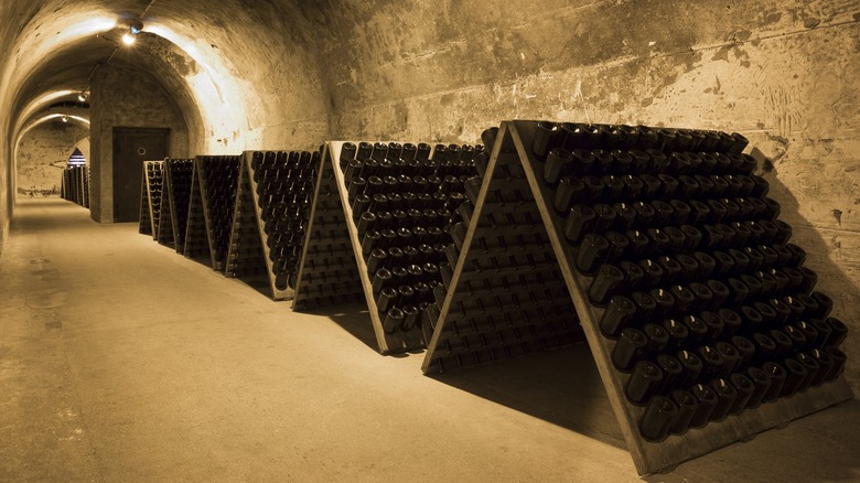 Champagne bottles aging in cellar