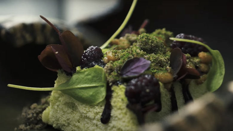 Dish with green foam and blackberries