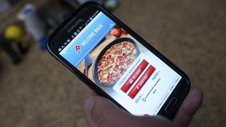 Person ordering Domino's on phone