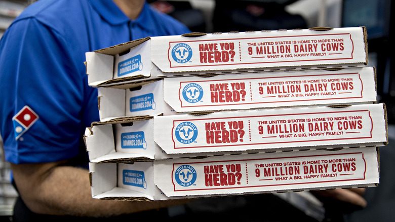 Domino's employee with pizza boxes