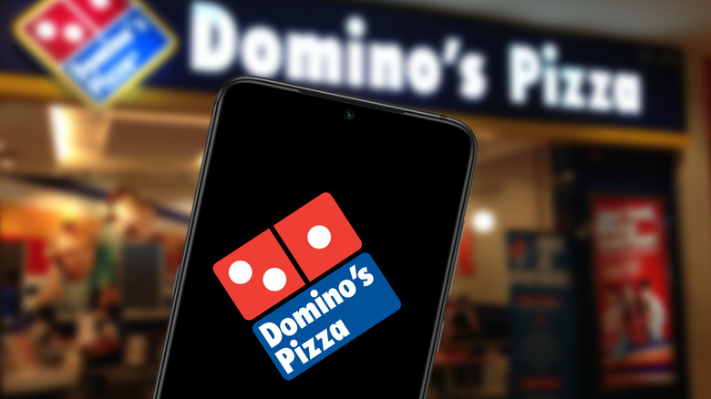 Domino's pizza mobile app with store in the background