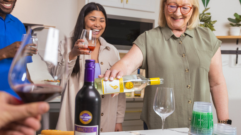 Donna Kelce pouring glass of Barefoot wine