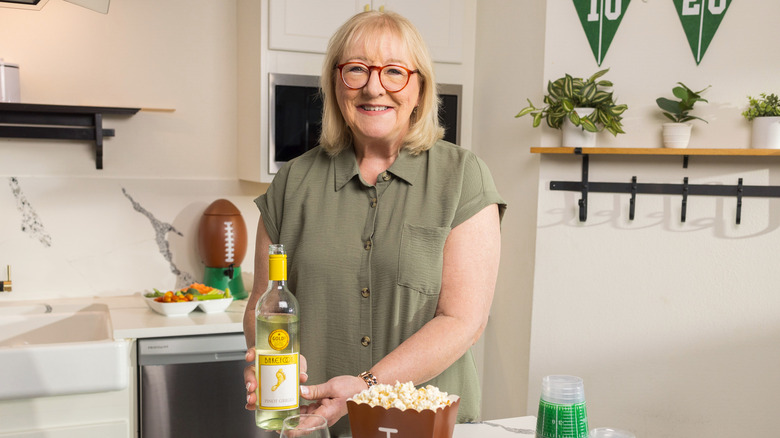 Donna Kelce holding bottle of Barefoot wine