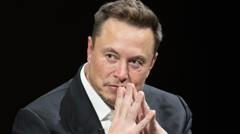 Elon Musk with hands folded