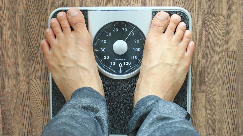 A man standing on the weight scale 