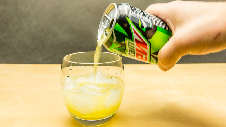 Pouring Mountain Dew into a glass