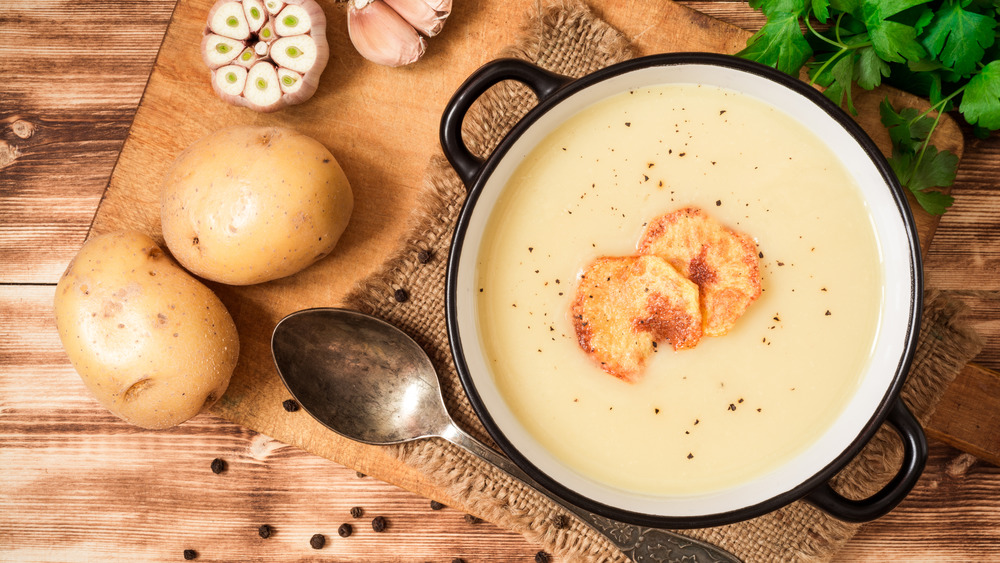 Potatoes with soup in pot