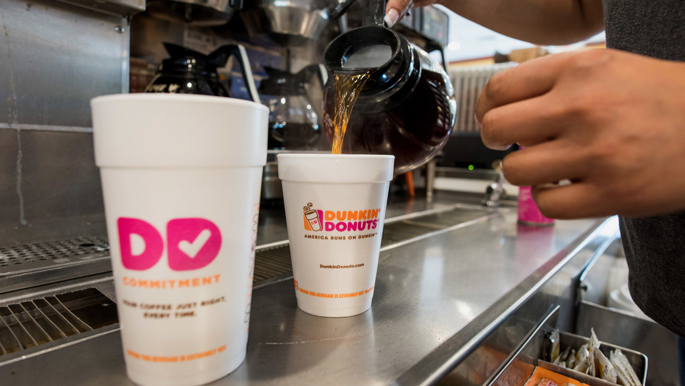  Dunkin' Donuts employee pouring coffee