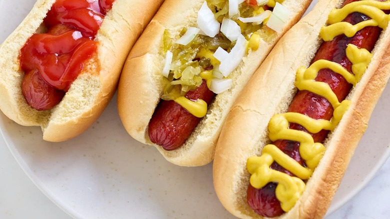 oven baked hot dogs with a variety of toppings