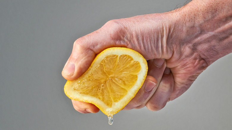 Man squeezing lemon