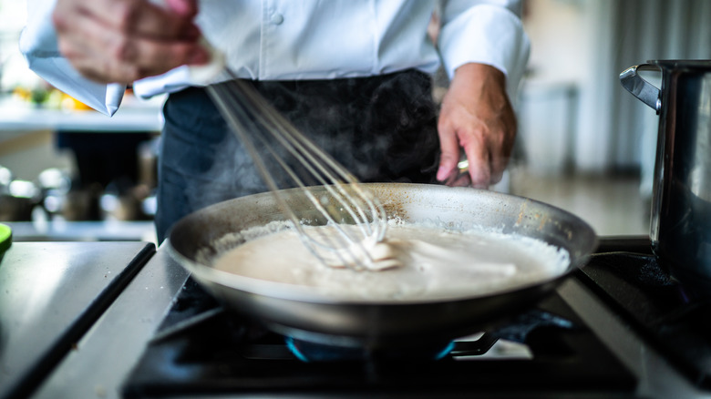 whisking bechamel sauce