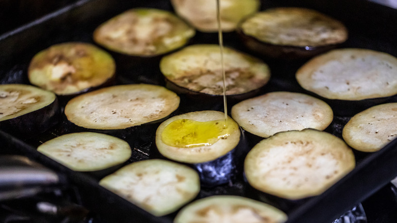 drizzling oil on eggplant slices