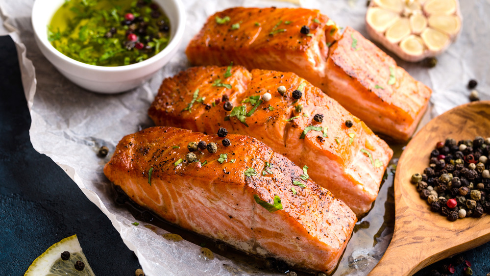 cooked salmon fillets on parchment paper