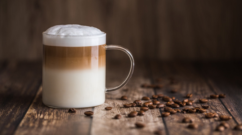 Latte on table with coffee beans